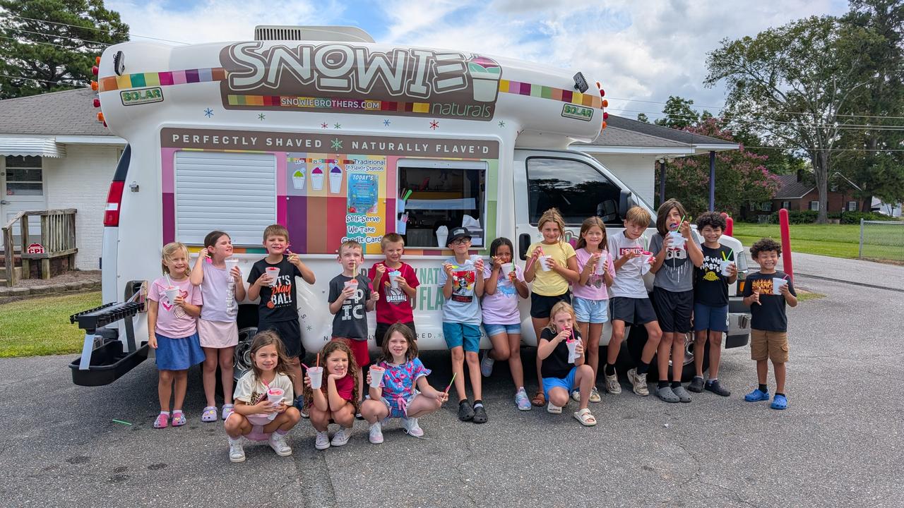 Premium shaved ice truck with customers at self-serve flavor station